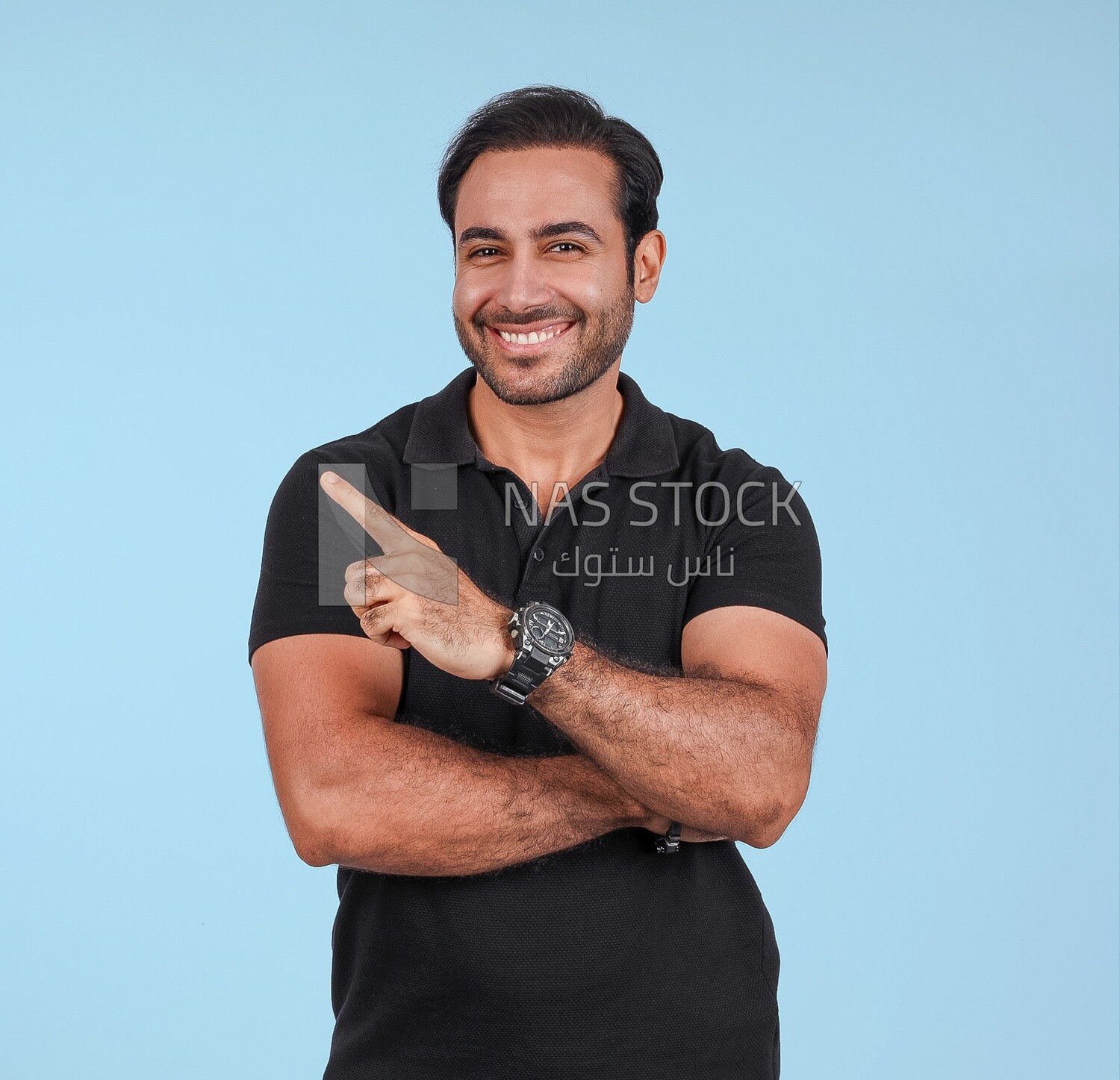 Photo Of a Handsome man Standing and pointing away, Smiling Man, Wearing Casual Clothes Posing In a Light Room Interior, Smiling At the Camera