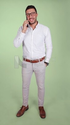 Portrait of a handsome man wearing glasses standing and talking on the phone, business development and partnerships, business meeting, model