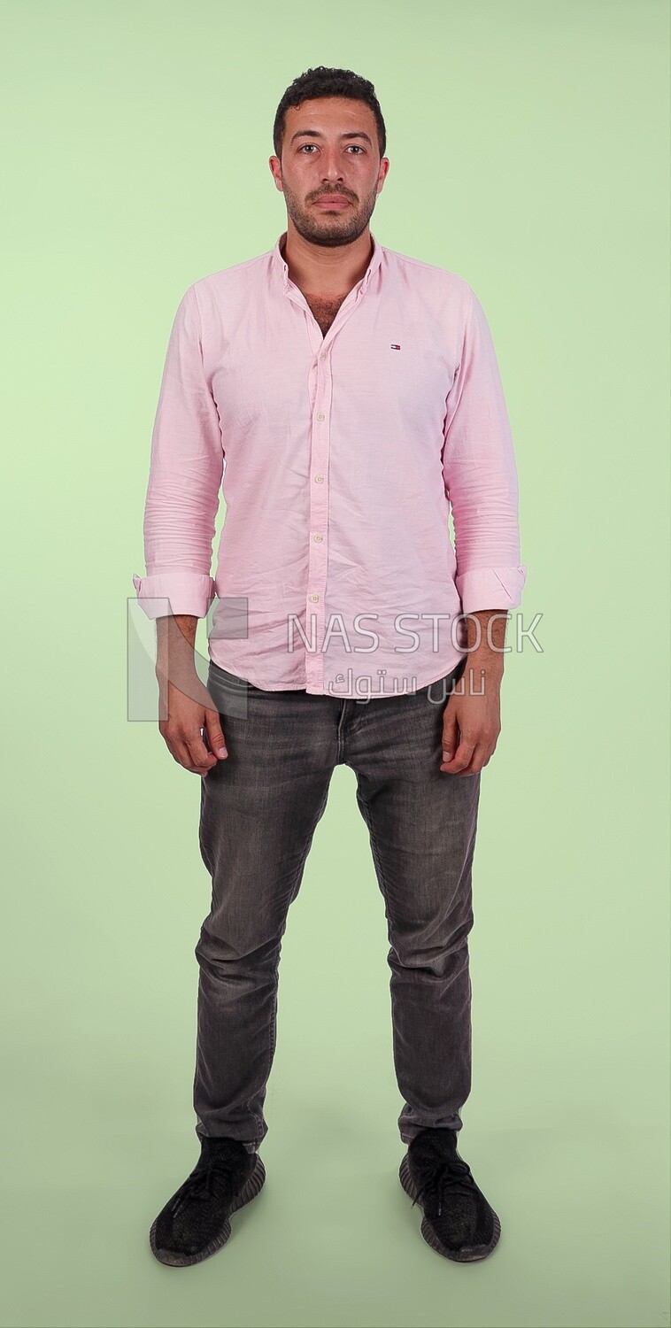 Photo Of Handsome man Standing, Smiling Man, Wearing Casual Clothes Posing In a Light Room Interior, Smiling At the Camera, looking away