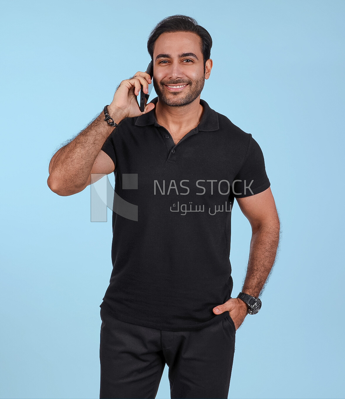 Photo Of a Handsome man Standing and talking in the mobile, Smiling Man, Wearing Casual Clothes Posing In a Light Room Interior, Smiling At the Camera