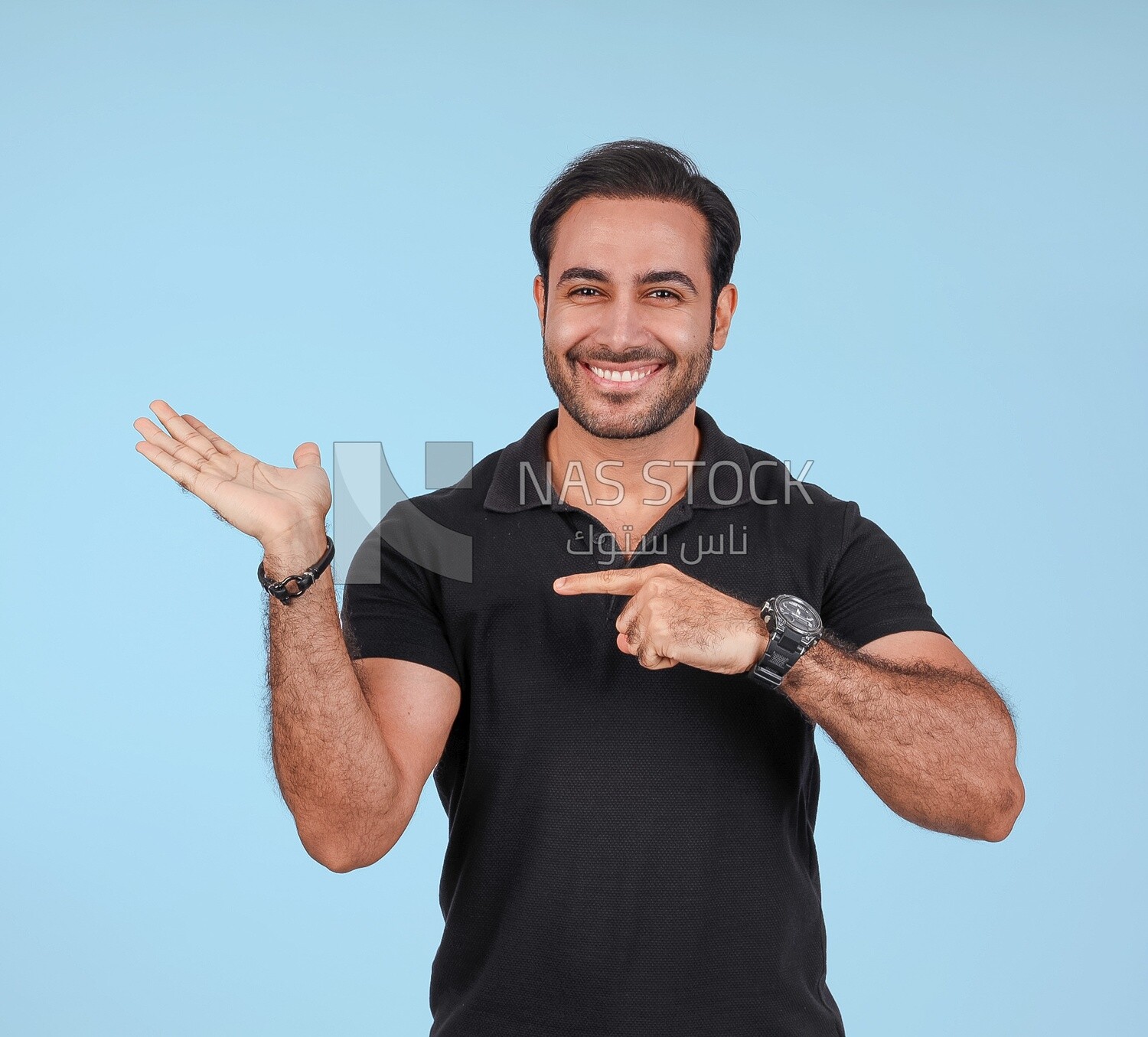 Photo Of a Handsome man Standing and pointing away, Smiling Man, Wearing Casual Clothes Posing In a Light Room Interior, Smiling At the Camera