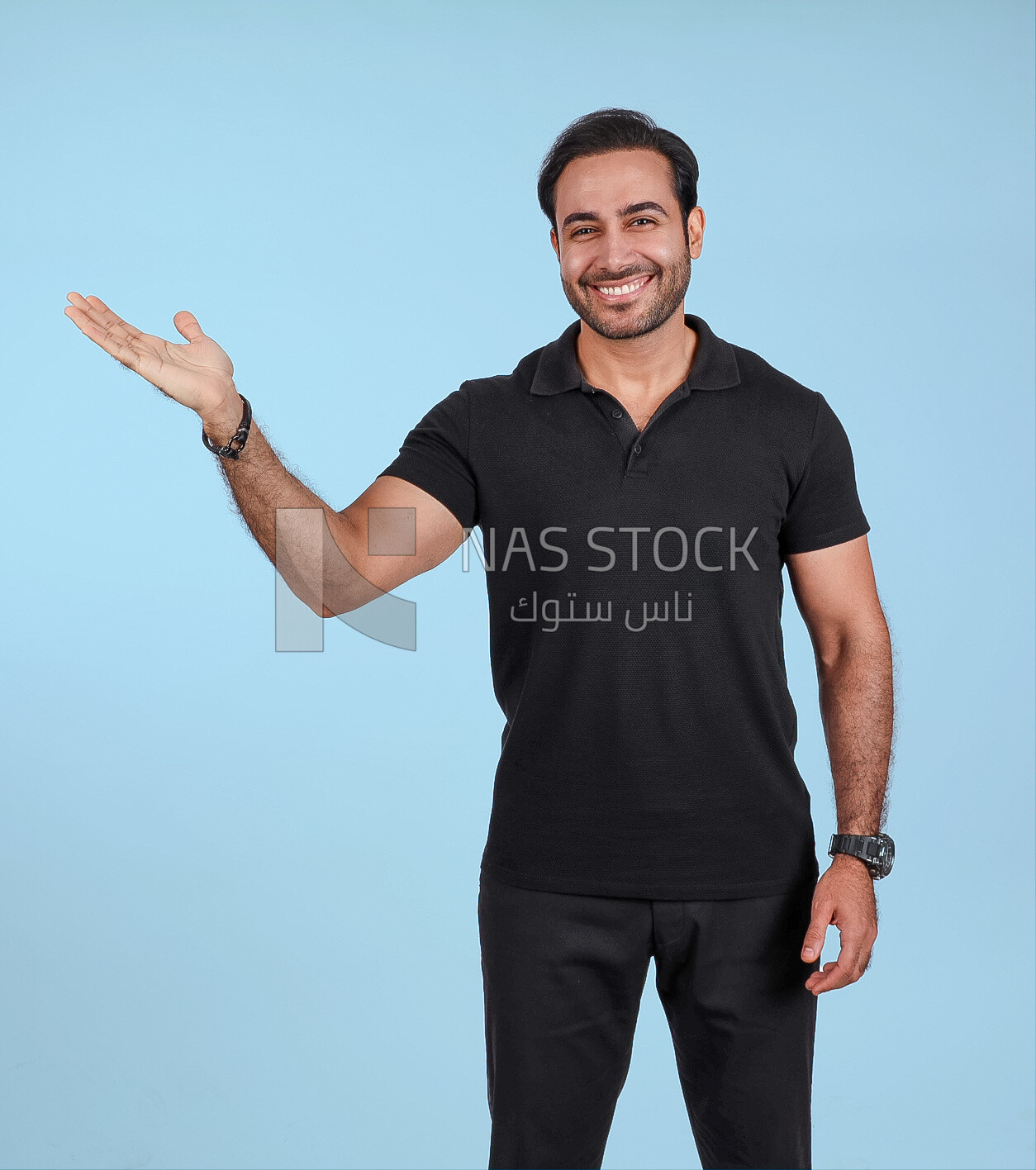 Photo Of a Handsome man Standing and pointing away, Smiling Man, Wearing Casual Clothes Posing In a Light Room Interior, Smiling At the Camera