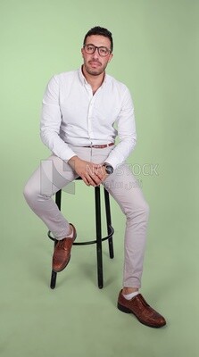 Photo of a handsome man with glasses sitting on a chair, business development and partnerships, business meeting, Model