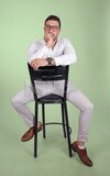 Photo of a handsome man with glasses sitting on a chair, business development and partnerships, business meeting, Model