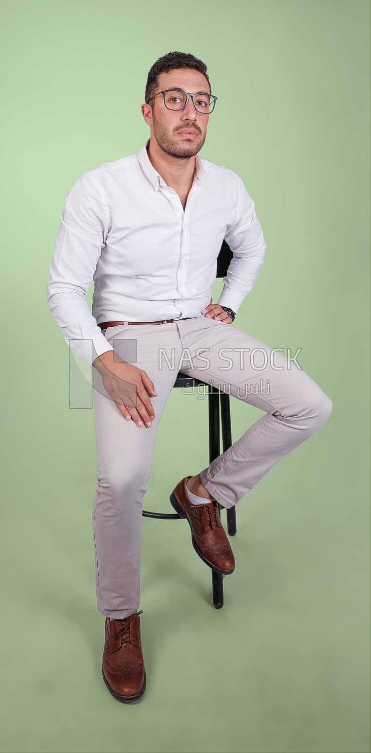 Photo of a handsome man with glasses sitting on a chair, business development and partnerships, business meeting, Model