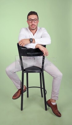 Photo of a handsome man with glasses sitting on a chair, business development and partnerships, business meeting, Model