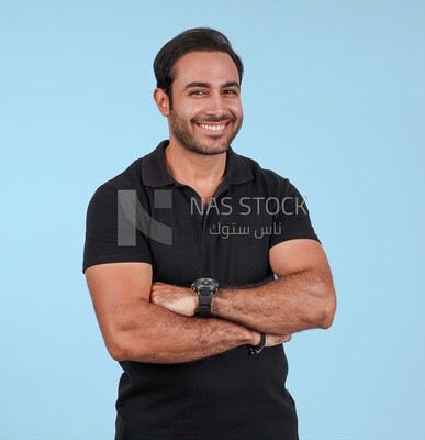 Photo Of a Handsome man Standing with crossed hands, Smiling Man, Wearing Casual Clothes Posing In a Light Room Interior, Smiling At the Camera