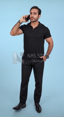 Photo Of a Handsome man Standing and talking in the mobile, Smiling Man, Wearing Casual Clothes Posing In a Light Room Interior, Smiling At the Camera