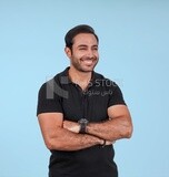 Photo Of a Handsome man Standing with crossed hands, Smiling Man, Wearing Casual Clothes Posing In a Light Room Interior, Smiling At the Camera