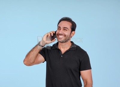 Photo Of a Handsome man Standing and talking in the mobile, Smiling Man, Wearing Casual Clothes Posing In a Light Room Interior, Smiling At the Camera