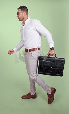 Photo of a handsome man wearing glasses and holding a leather bag, business and partnership development, business meeting, model