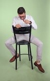 Photo of a handsome man with glasses sitting on a chair, business development and partnerships, business meeting, Model