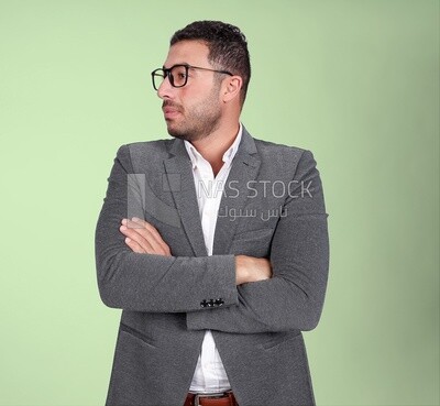 Portrait of a handsome man standing with glasses wearing a formal suit looking away, business development and partnerships, business meeting, Model