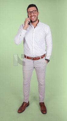 Portrait of a handsome man wearing glasses standing and talking on the phone, business development and partnerships, business meeting, model