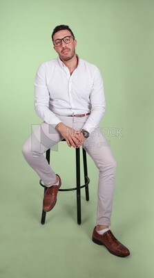 Photo of a handsome man with glasses sitting on a chair, business development and partnerships, business meeting, Model