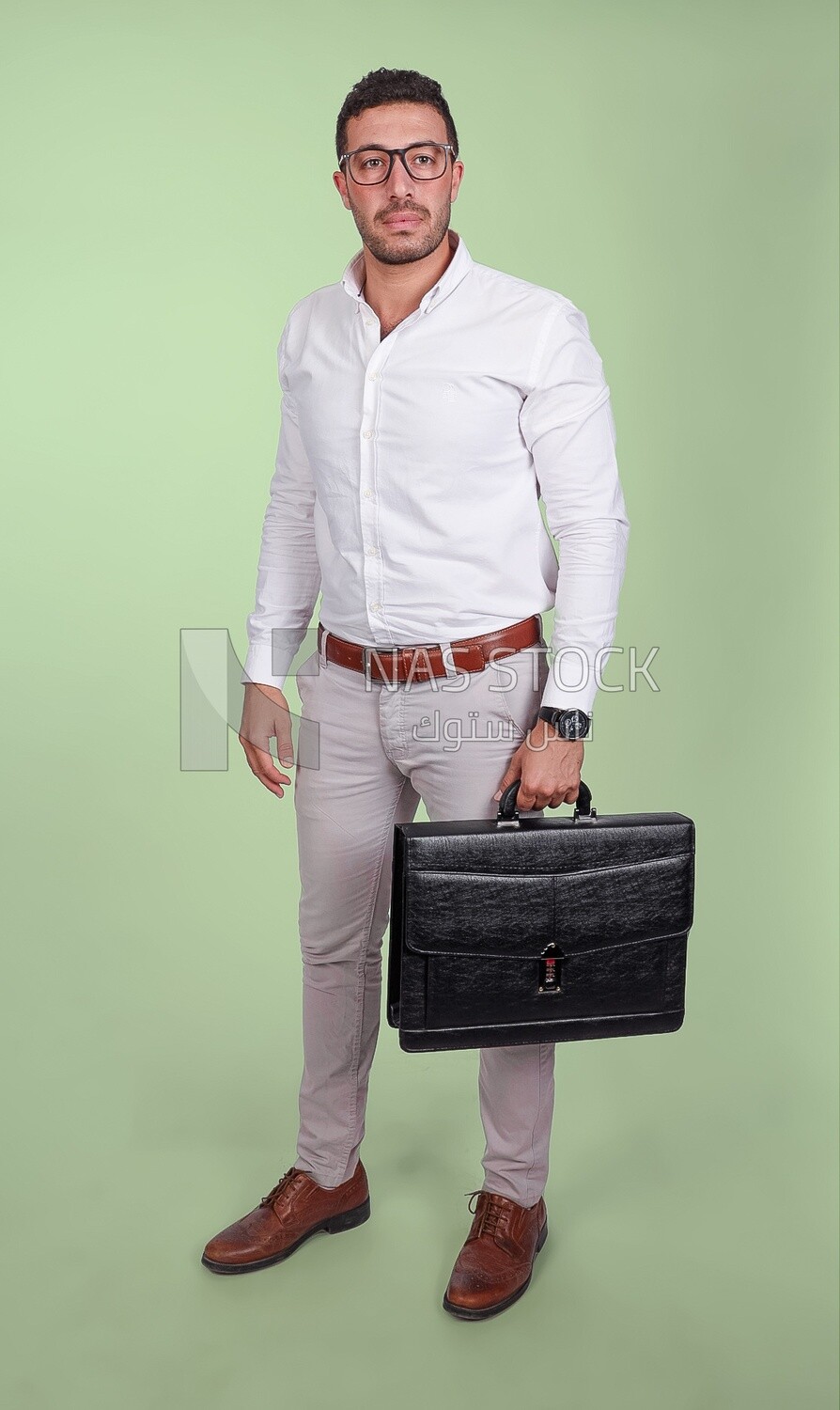 Photo of a handsome man wearing glasses and holding a leather bag, business and partnership development, business meeting, model