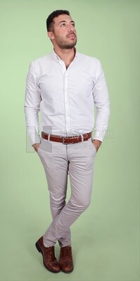 Photo of a handsome man standing and putting his hand in his pocket, a smiling man, dressed casually in an indoor light room, smiling at the camera, looking away