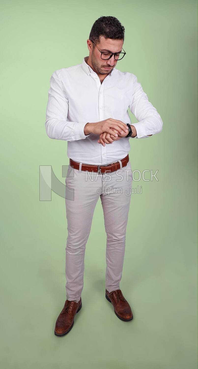 Photo of a handsome man wearing glasses looking at the watch, business and partnership development, business meeting, model