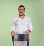 Photo of a handsome man wearing glasses standing and leaning on a chair, business development and partnerships, business meeting, model