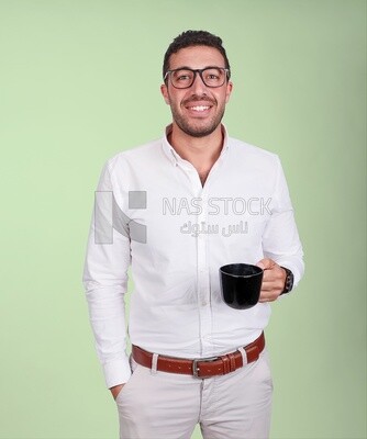 Photo of a handsome man wearing glasses standing holding a cup of coffee, business development and partnerships, business meeting, model