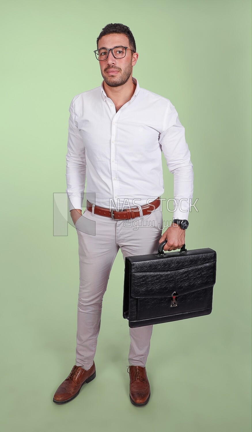 Photo of a handsome man wearing glasses and holding a leather bag, business and partnership development, business meeting, model