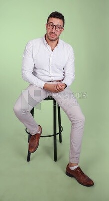 Photo of a handsome man with glasses sitting on a chair, business development and partnerships, business meeting, Model