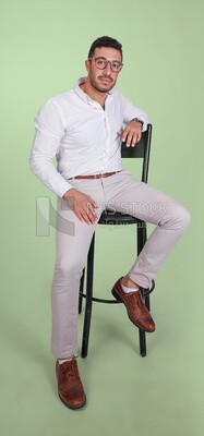 Photo of a handsome man with glasses sitting on a chair, business development and partnerships, business meeting, Model