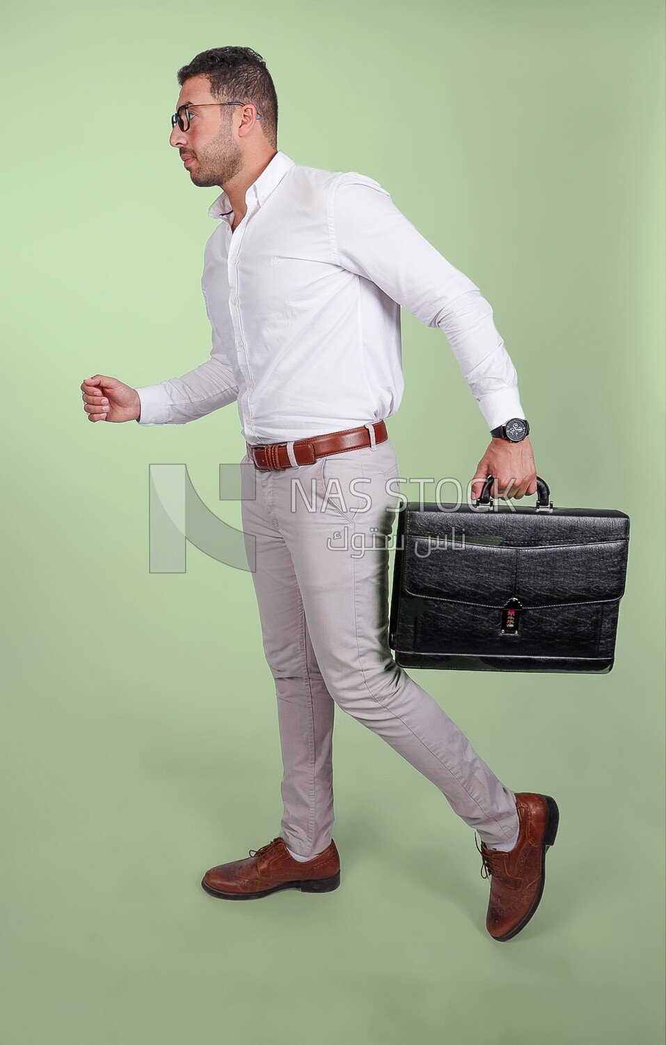 Photo of a handsome man wearing glasses and holding a leather bag, business and partnership development, business meeting, model