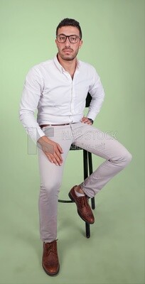 Photo of a handsome man with glasses sitting on a chair, business development and partnerships, business meeting, Model