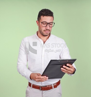 Photo of a handsome man with glasses and reading from a paper clipboard, business development and partnerships, business meeting, Model