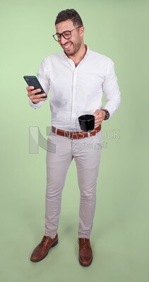 Photo of a handsome man wearing glasses standing looking at his phone and drinking coffee, business development and partnerships, business meeting, model