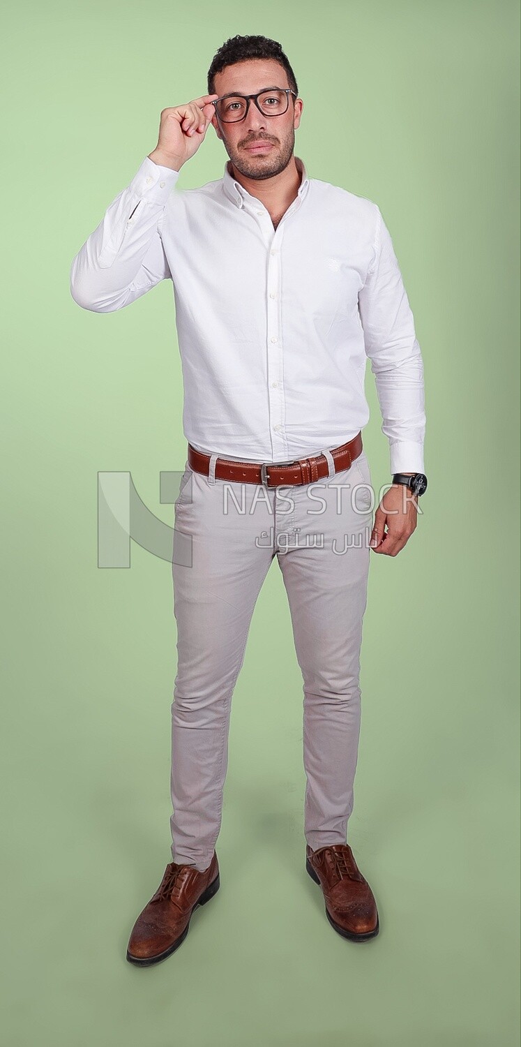 Portrait of a man with glasses putting his hand on it wearing formal wear, business development and partnerships, business meeting, Model