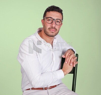 Portrait of a handsome man with glasses sitting on a chair, business development and partnerships, business meeting, Model