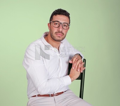 Portrait of a handsome man with glasses sitting on a chair, business development and partnerships, business meeting, Model