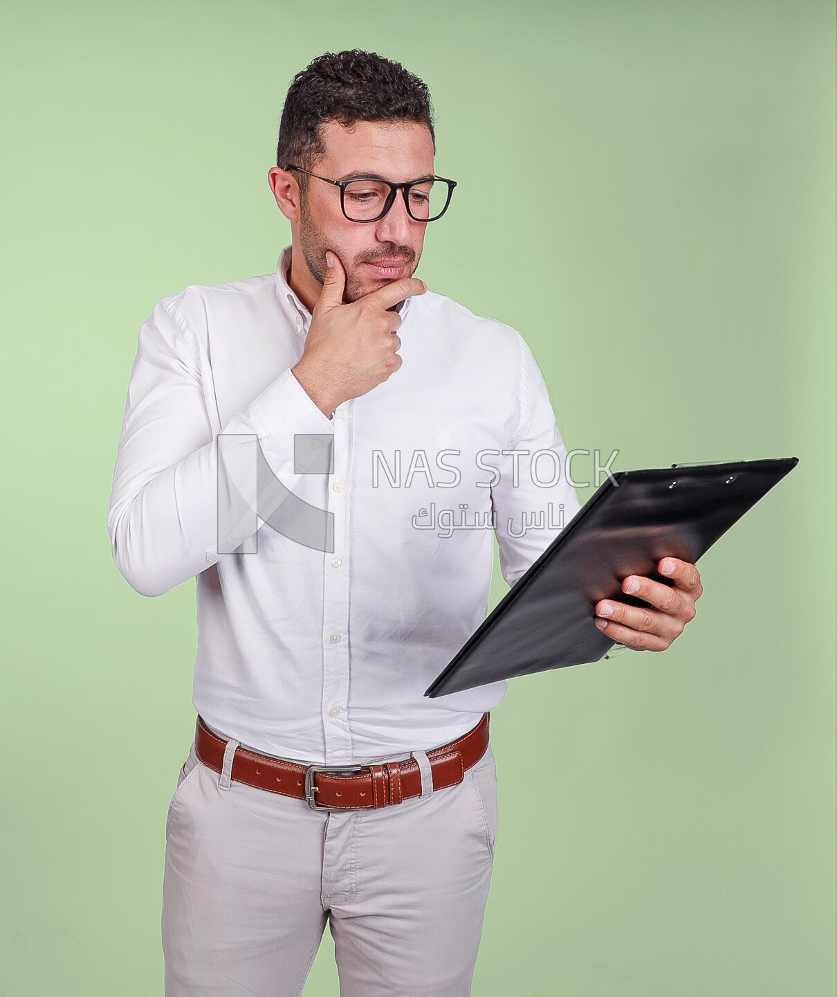 Photo of a handsome man with glasses and reading from a paper clipboard, business development and partnerships, business meeting, Model