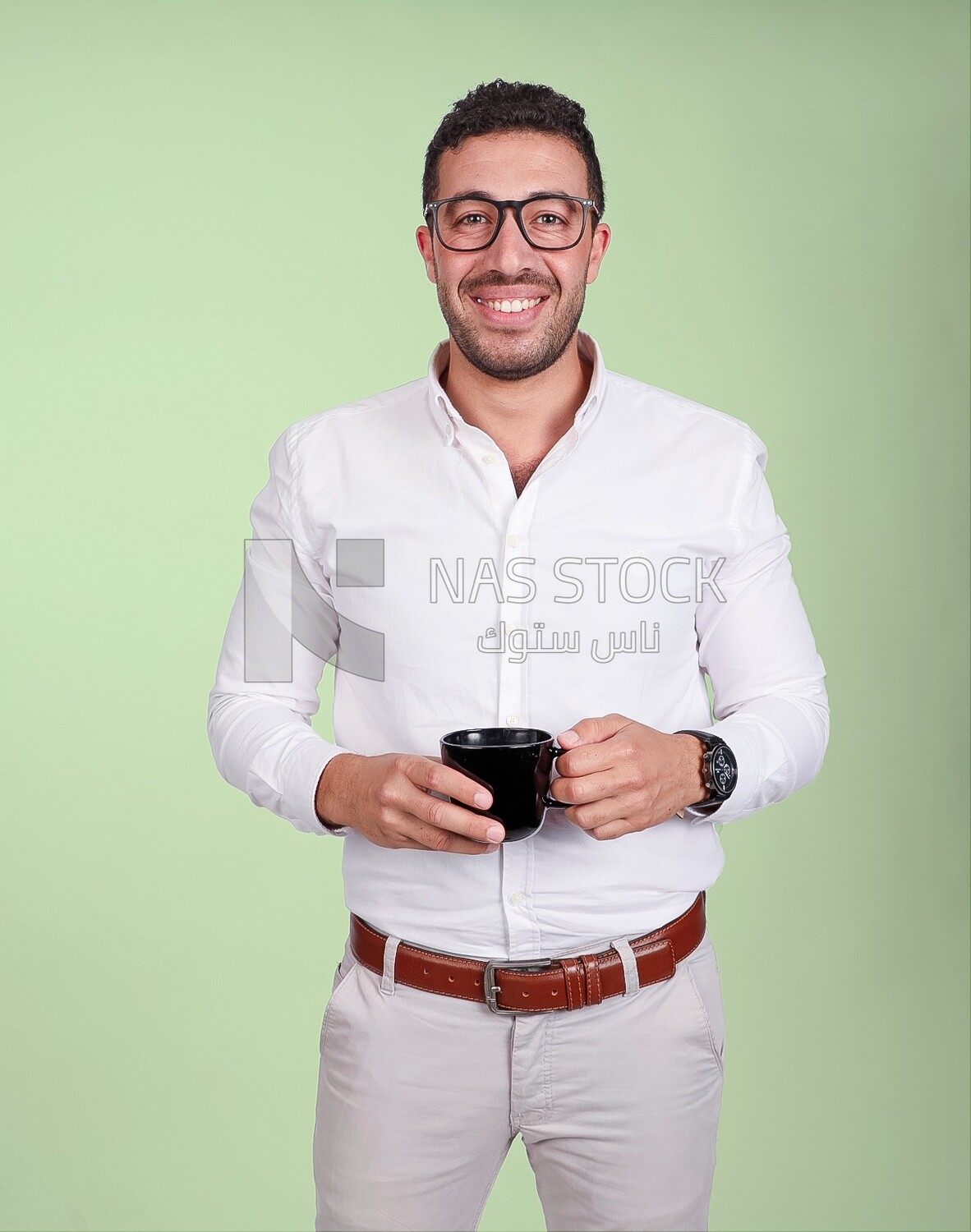Photo of a handsome man wearing glasses and standing holding a cup of coffee, business development and partnerships, business meeting, model