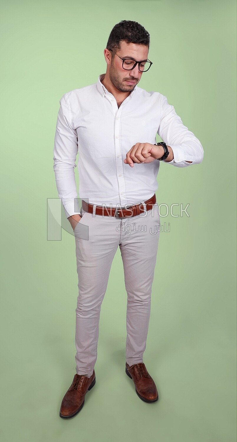 Photo of a handsome man wearing glasses looking at the watch, business and partnership development, business meeting, model