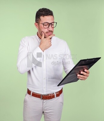 Photo of a handsome man with glasses and reading from a paper clipboard, business development and partnerships, business meeting, Model