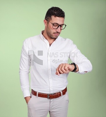 Photo of a handsome man wearing glasses looking at the watch, business and partnership development, business meeting, model