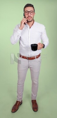 Photo of a handsome man wearing glasses standing talking on his phone and drinking coffee, business development and partnerships, business meeting, model