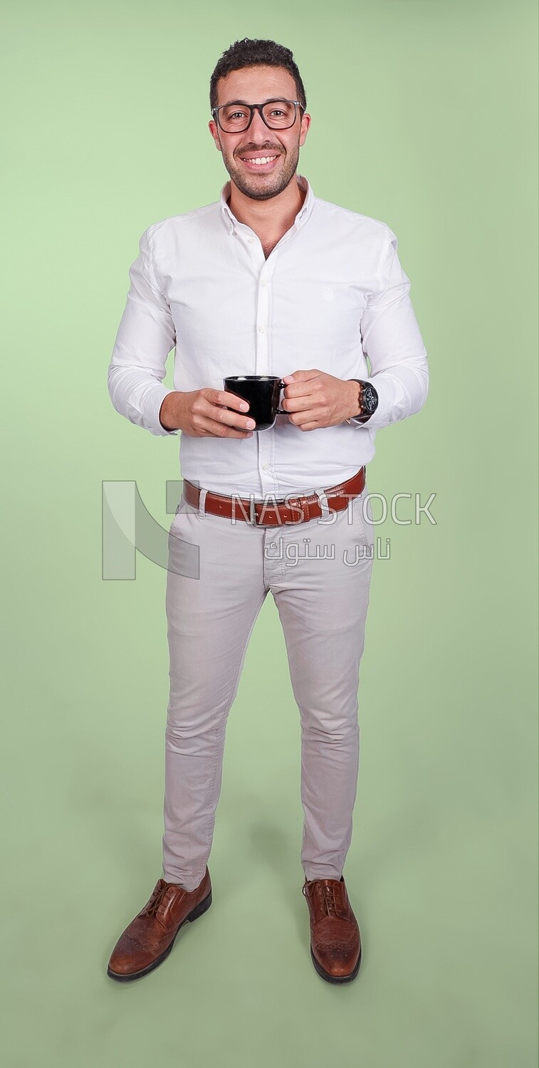 Photo of a handsome man wearing glasses and standing holding a cup of coffee, business development and partnerships, business meeting, model
