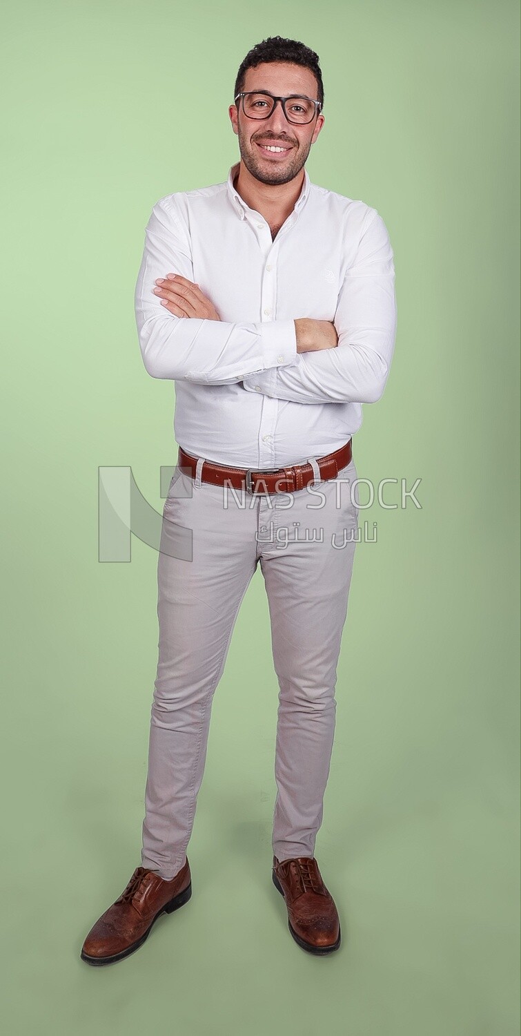 Portrait of a handsome man standing with glasses wearing formal wear with crossed hands, business development and partnerships, business meeting, Model
