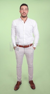 Photo of a handsome man standing and putting his hand in his pocket, a smiling man, dressed casually in an indoor light room, smiling at the camera, looking away
