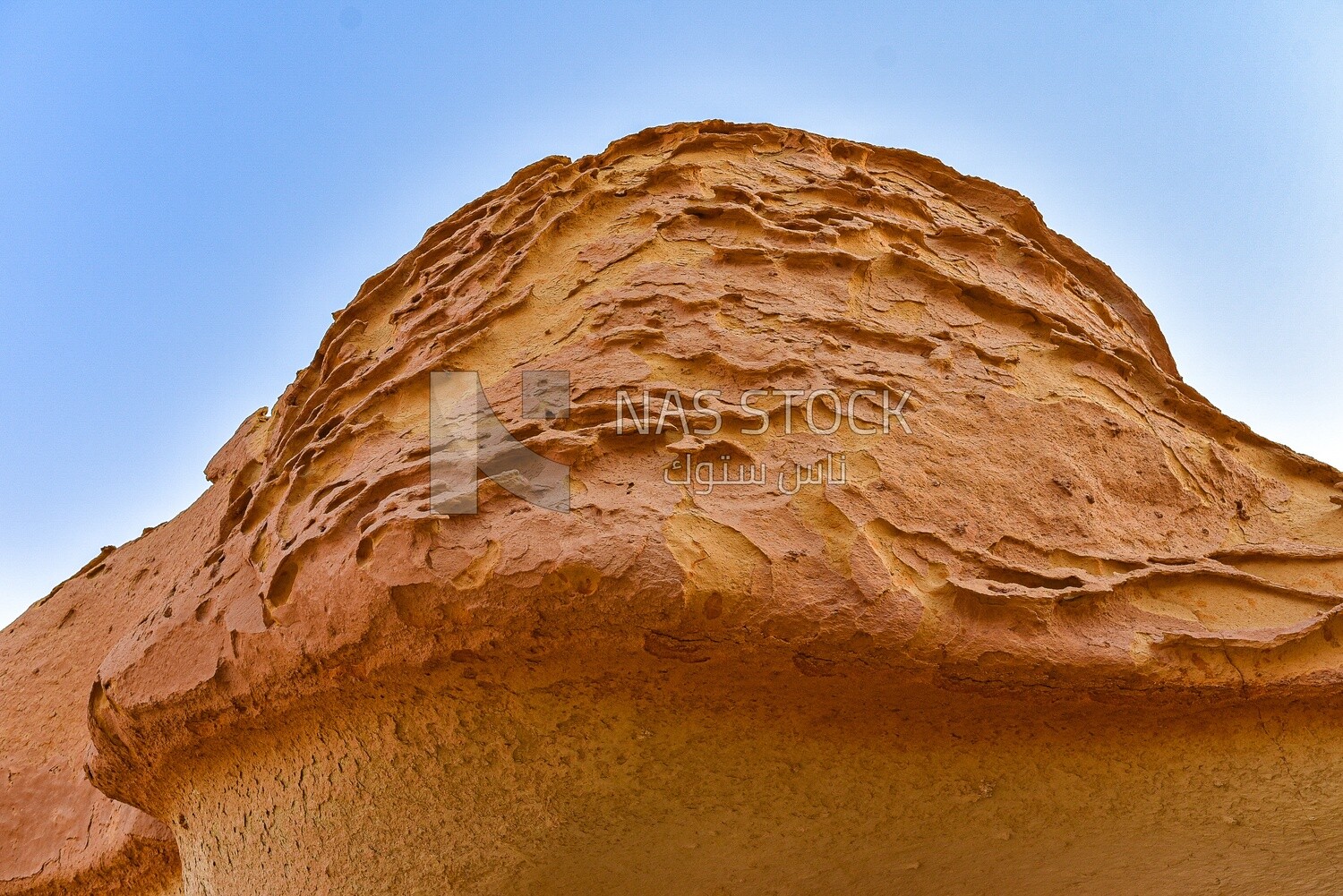 A scene of rock formations on a sandy mountain in the Wadi El Hitan desert in Egypt