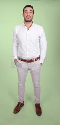 Photo of a handsome man standing and putting his hand in his pocket, a smiling man, dressed casually in an indoor light room, smiling at the camera, looking away
