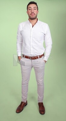 Photo of a handsome man standing and putting his hand in his pocket, a smiling man, dressed casually in an indoor light room, smiling at the camera, looking away