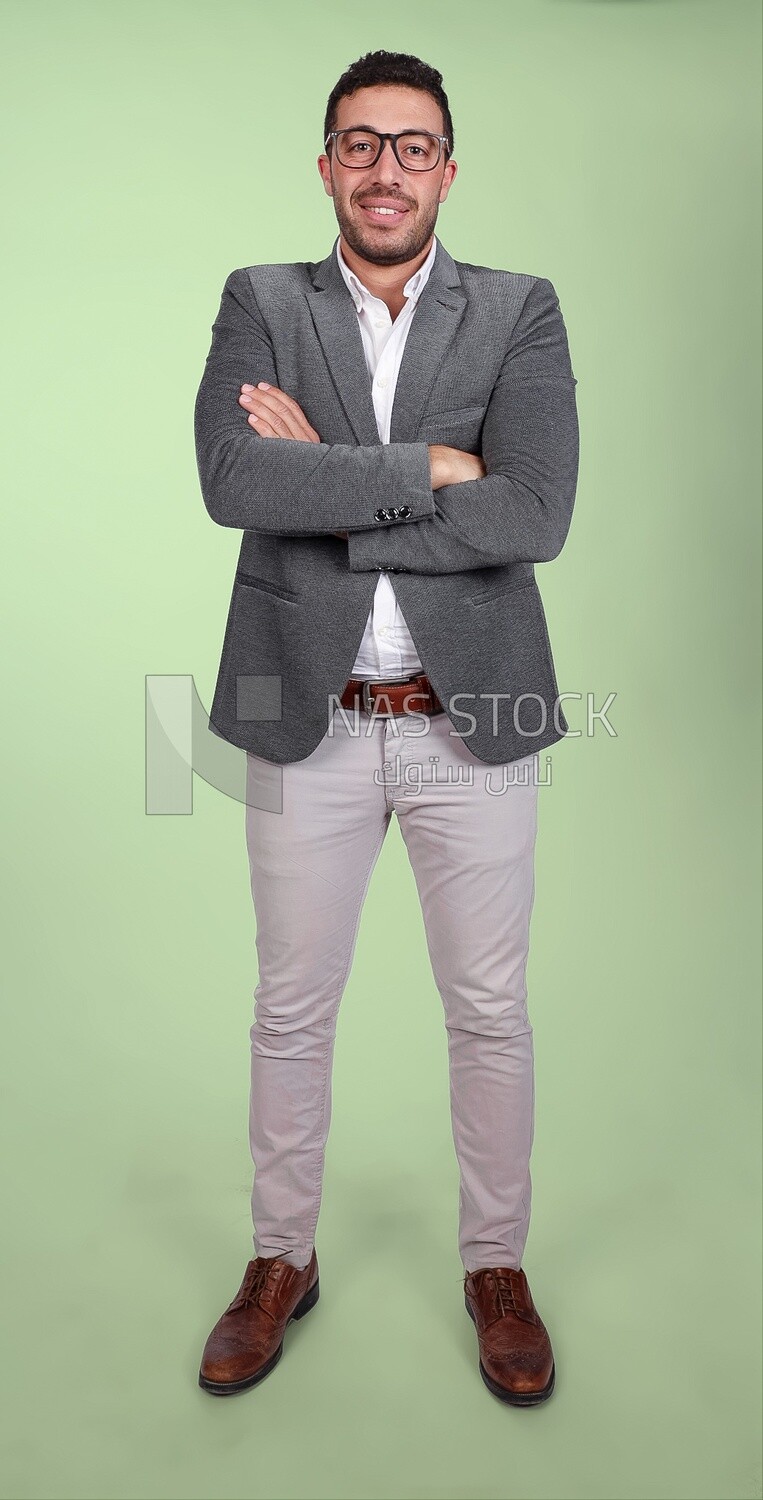 Portrait of a handsome man standing wearing formal wear with crossed hands, business development and partnerships, business meeting, Model