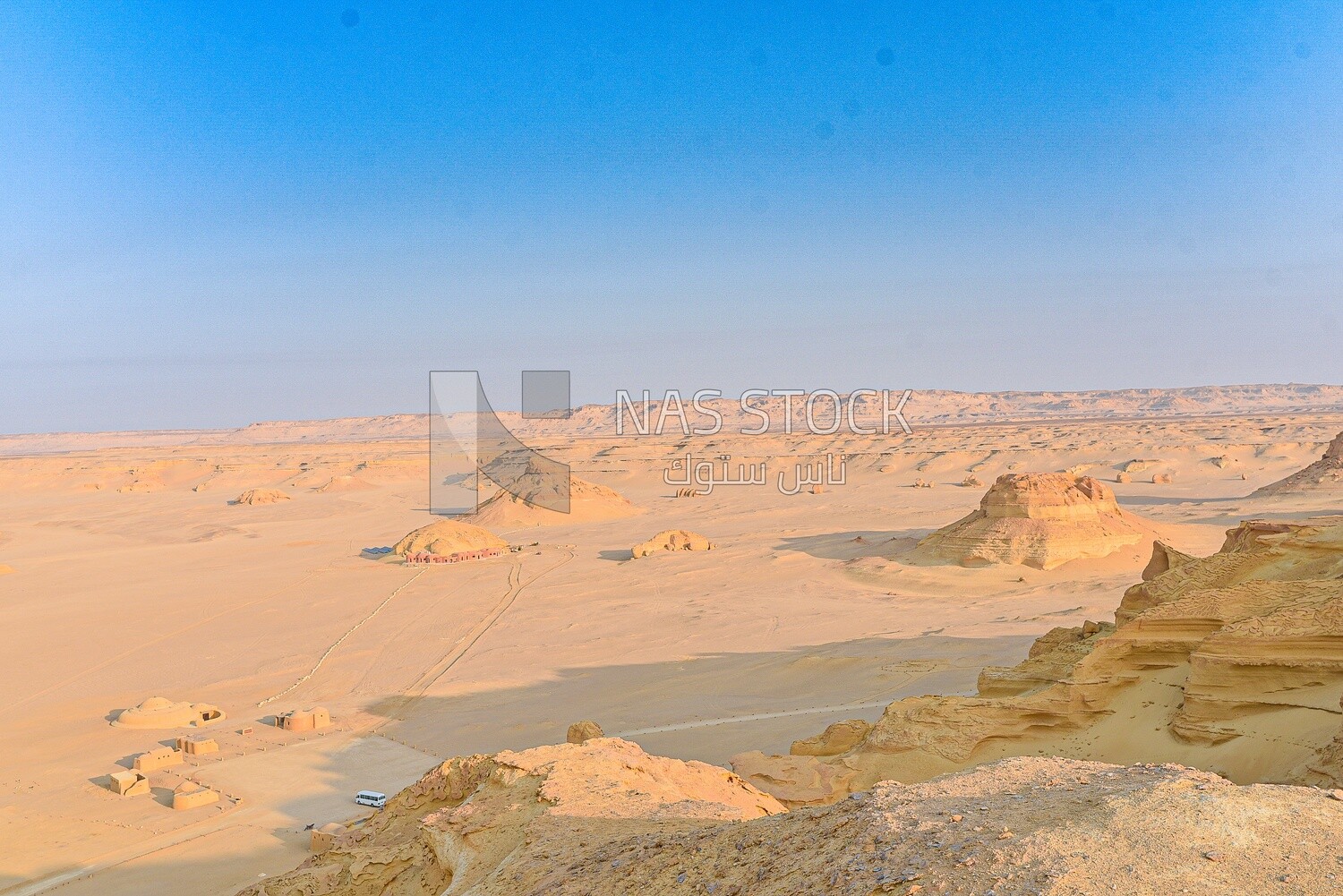 A scene of stones and sand dunes in Wadi El Hitan, Egypt