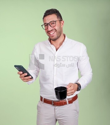 Photo of a handsome man wearing glasses standing and checking his phone, business development and partnerships, business meeting, model