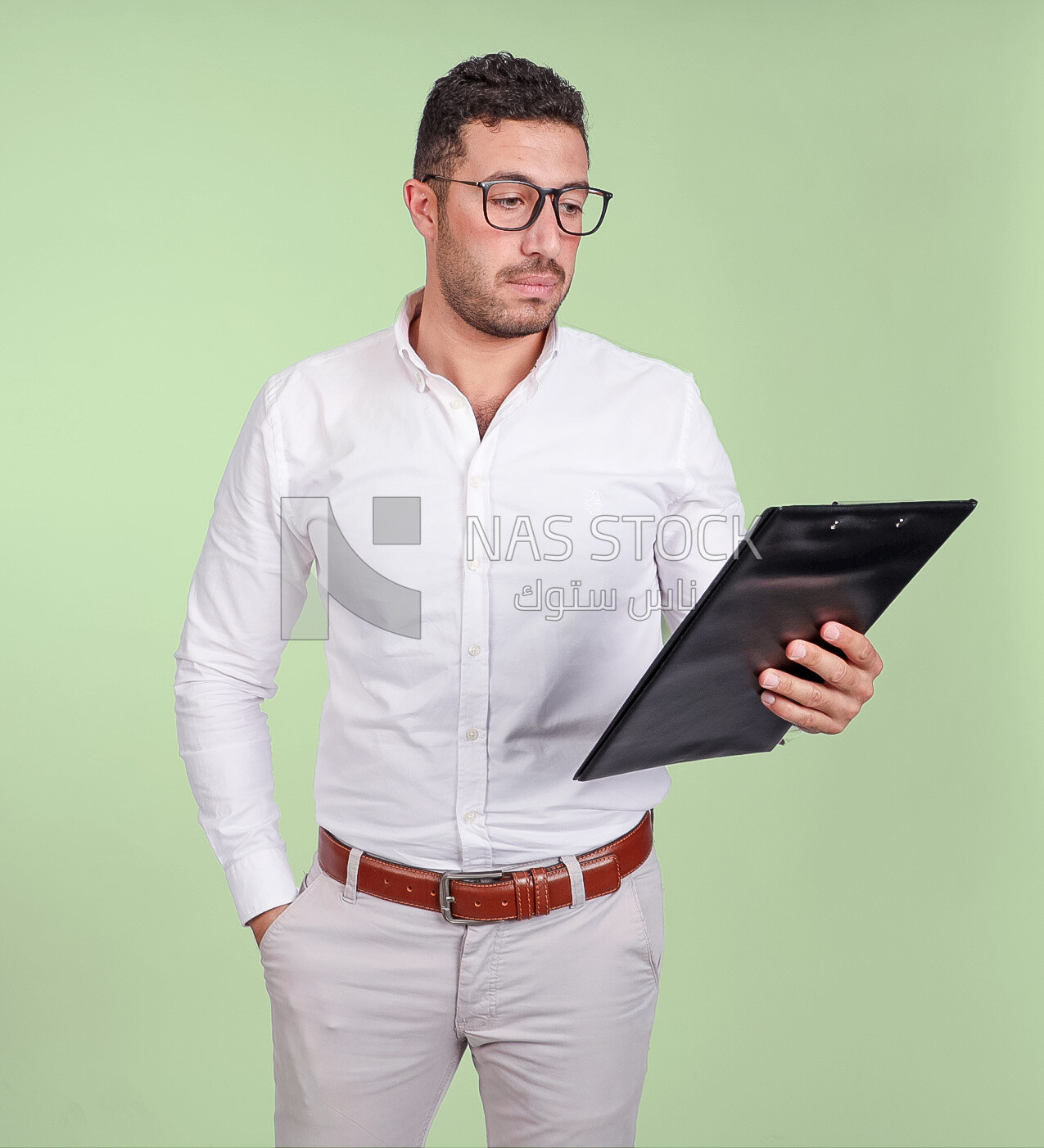 Photo of a handsome man with glasses and reading from a paper clipboard, business development and partnerships, business meeting, Model